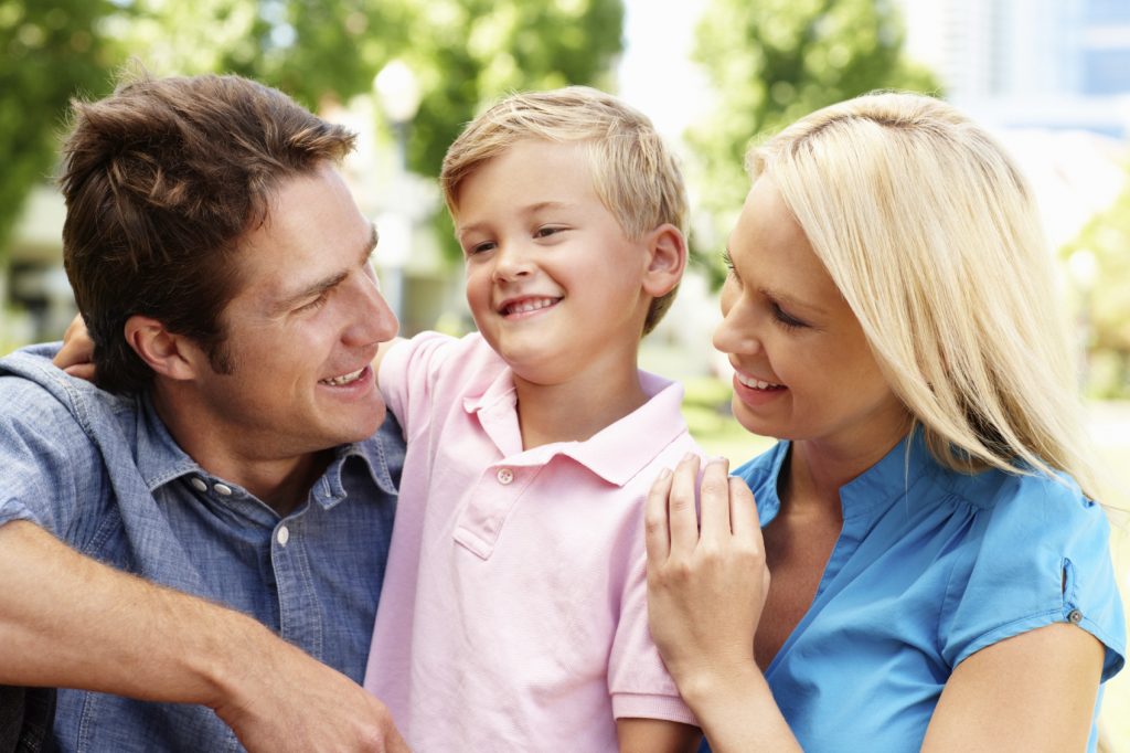 Couple in city park with young son